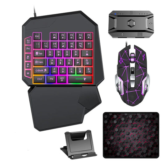Gaming keyboard, mouse, converter, mousepad, and phone holder on a white background